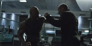 Deckard Shaw (Jason Statham) and Luke Hobbs (Dwayne "The Rock" Johnson) battle in the DSS offices.