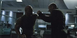  Deckard Shaw (Jason Statham) and Luke Hobbs (Dwayne "The Rock" Johnson) battle in the DSS offices.  