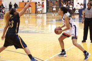 Senior Dinah Jones looks to pass to an open teammate against Coppin State University. Photo by Terry Wright.