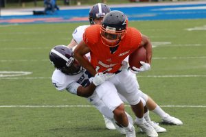 Senior receiver Thomas Martin fights for extra yards after a reception against Holy Cross. Photo by Terry Wright.