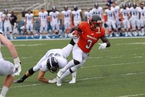 Herb Walker avoids Holy Cross tackler. Photo by Terry Wright.