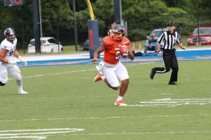 Graduate quarterback Chris Andrews scans the field against Holy Cross. Photo by Terry Wright.