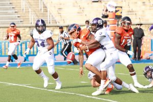 Holy Cross' Chase Stanton forces a fumble on graduate quarterback Chris Andrews. Photo by Terry Wright.