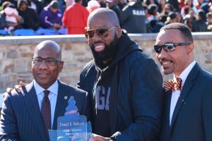 Morgan alum and producer of "Almost Christmas" David Talbert (center) along with campus president David Wilson (left) and Kweisi Mfume (right) at halftime of Saturday's homecoming game against NCCU.