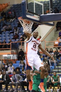 Senior Kyle Thomas completes a dunk against Wilmington University. Photo by Terry Wright