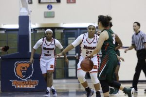 Freshman guards Kaylin Ellis (22) and Jihayah Chavis (4) defend the basket in the second half of a 61-26 loss to FAMU. Photo by Wyman Jones