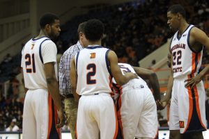 Kyle Thomas (21), Martez Cameron (2), and Phillip Carr (22) help Tiwain Kendley (5) up after a hard fall. Photo by Wyman Jones.