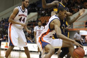 Junior forward Phillip Car dribbles for better position against Coppin State University. Photo by Wyman Jones.