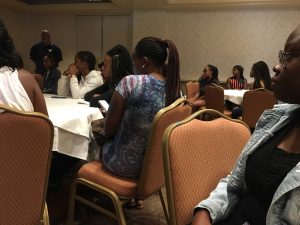 Students and their parents listening to Morgan State officials go over rules while staying in hotel.